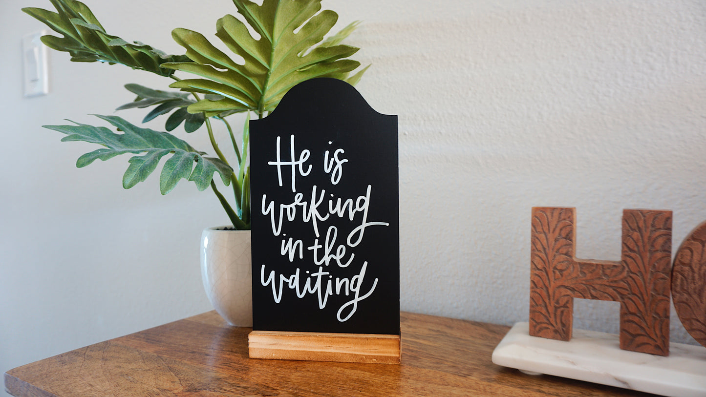 He is Working in the Waiting - Tabletop Chalkboard Sign with Base