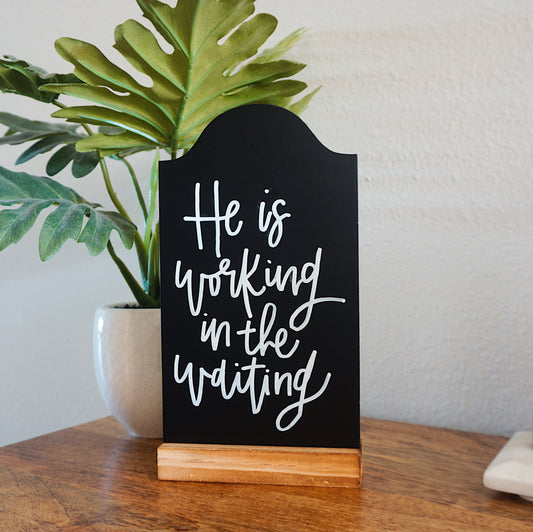 He is Working in the Waiting - Tabletop Chalkboard Sign with Base